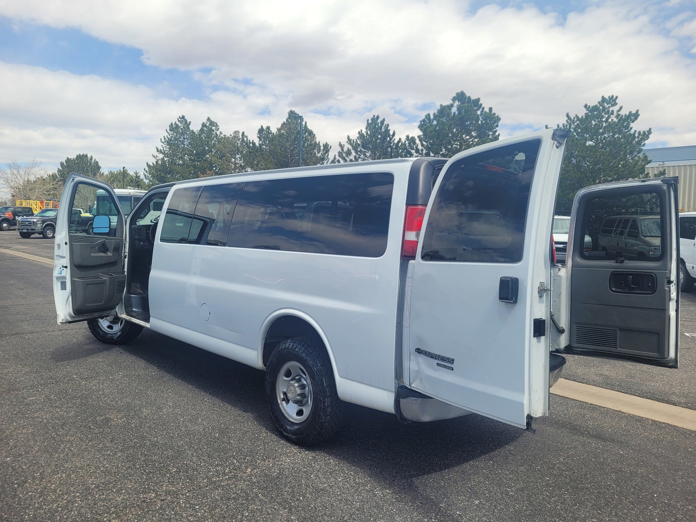 White Chevrolet Express van with open driver and rear doors, well-suited for an rv rental conversion or group transport. — photo 2