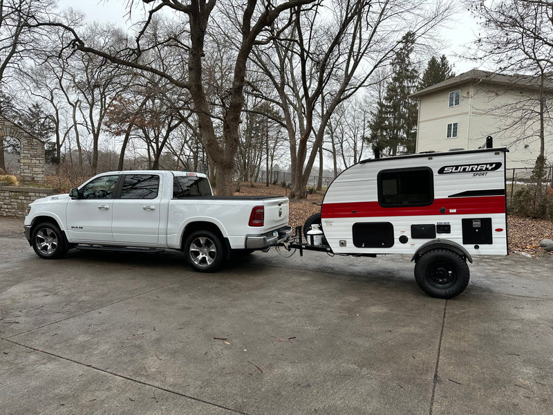 White RAM pickup towing a SunRay Sport teardrop camper, perfect for an RV rental adventure! — photo 15