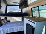 Van life ready! This RV rental features bunk beds, a kitchen, and stunning snowy mountain views.
