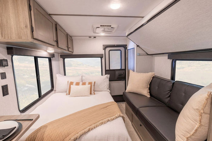  plus storage and exterior features.|A modern RV rental kitchen and dining area features a stainless steel fridge
