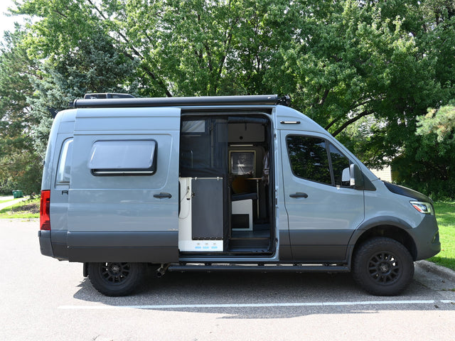 Custom grey camper van with open side door showing interior