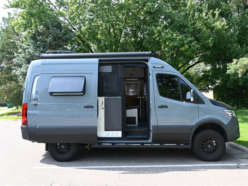 Custom grey camper van with open side door showing interior — photo 1