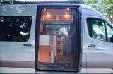Explore this RV rental's spacious interior! Side door open on a gray van reveals kitchen, cabinets, and cozy lighting.