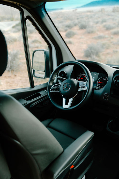 Step into this comfortable RV rental. The spacious interior features a modern Mercedes dashboard and steering wheel, perfect for desert road trips.