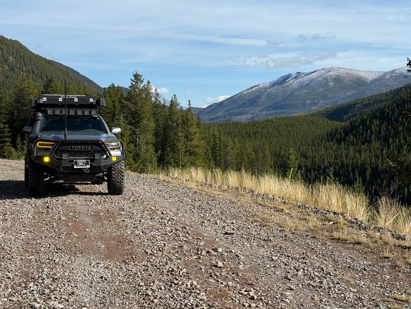 Explore mountain trails with this rugged Toyota Tacoma, ideal for an overlanding rv rental adventure in nature.