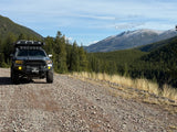 Explore mountain trails with this rugged Toyota Tacoma, ideal for an overlanding rv rental adventure in nature.