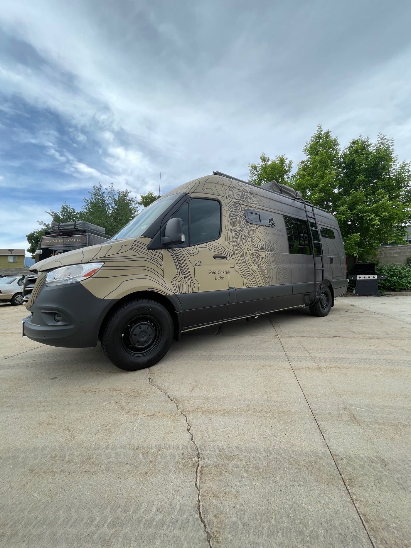  and dining table with backgammon board.|This modern RV rental interior offers a rear bed — photo 10