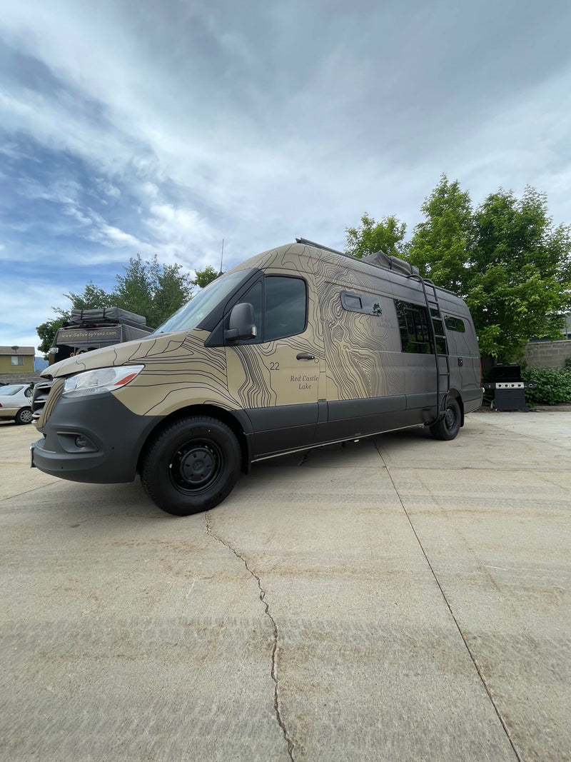  and dining table with backgammon board.|This modern RV rental interior offers a rear bed — photo 10