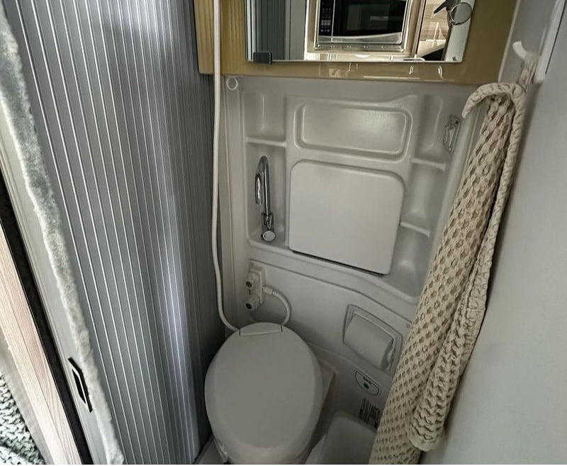  and entertainment amenities.|Inside this modern RV rental: compact kitchen with sink — photo 6