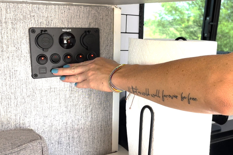 Activating cabin lights on an RV rental's Nilight control panel, showing a voltage meter. Essential for comfortable travel. — photo 19