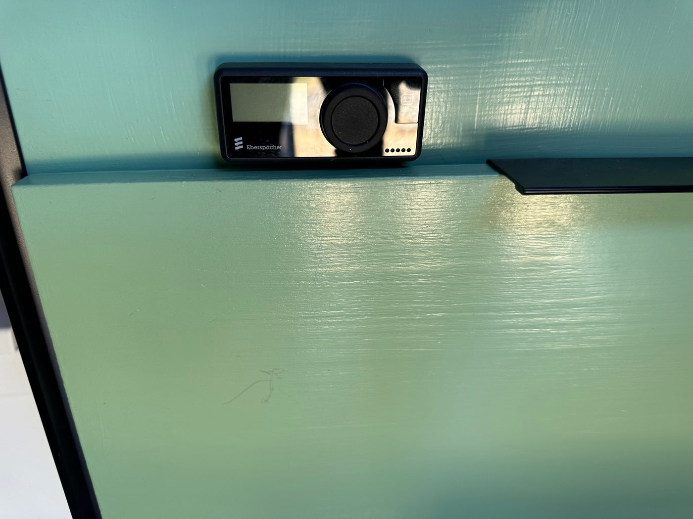 Wall-mounted Eberspächer climate control unit with a screen and knob, common in an RV rental. — photo 15