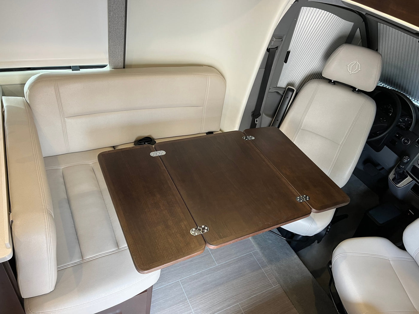  and a fire extinguisher.|Spacious rv rental interior seen through windshield. Features light front seats with logo — photo 13