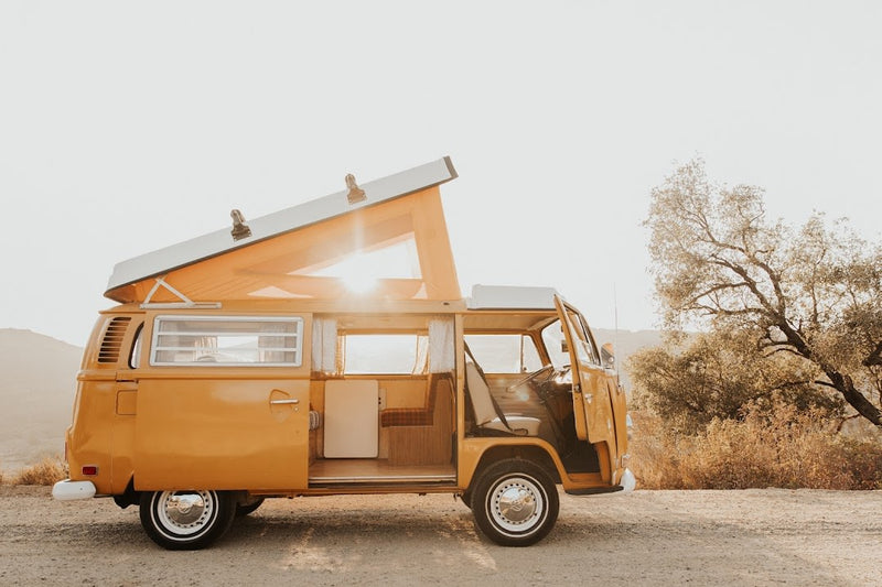 Rv rental: A sunny, orange vintage VW camper van with open pop-top & doors, ready for a road trip adventure. — photo 1