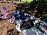RV rental campsite ready! Portable stove, coffee maker, dishes, and chairs set for outdoor cooking & relaxation.