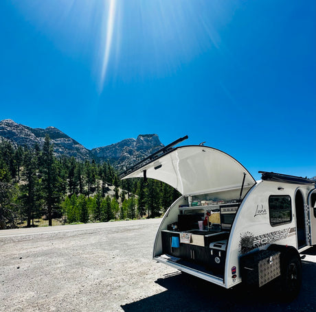 Sunny mountain stop with our Luna Rover rv rental. This tear-drop camper's outdoor kitchen is perfect for adventure cooking.