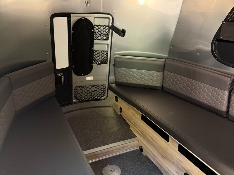  ready for outdoor adventure.|Modern RV rental interior: gray padded seating with hexagon pattern — photo 2
