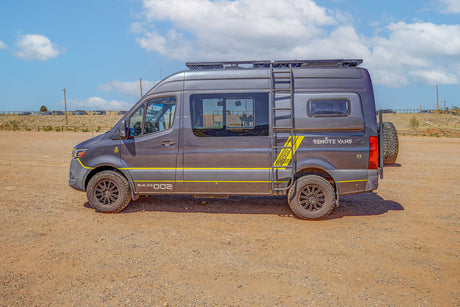 Custom grey Remote Vans adventure van with yellow details & off-road tires. Perfect RV rental for exploring.