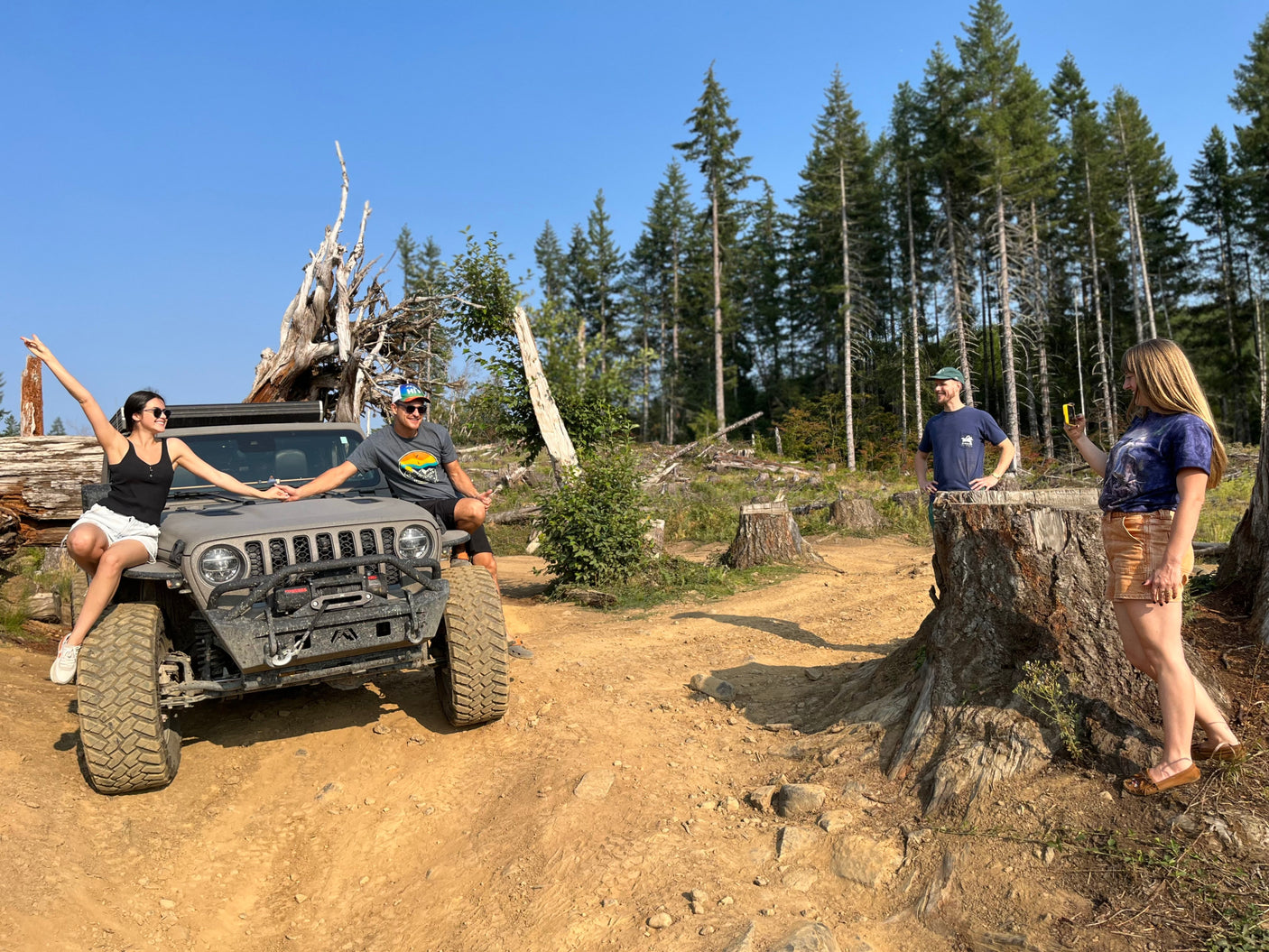 Four friends on an off-road Jeep adventure in the woods. Explore nature, whether by Jeep or your next RV rental trip!