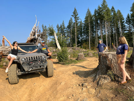 Four friends on an off-road Jeep adventure in the woods. Explore nature, whether by Jeep or your next RV rental trip!