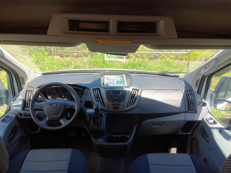 View of an RV rental's Ford Transit van interior, featuring the dashboard, steering wheel, and front seats. — photo 3