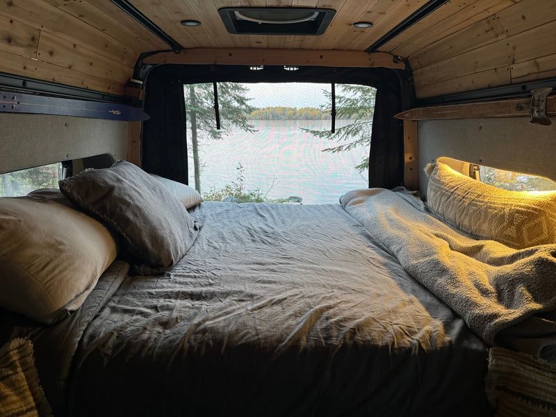  ready for comfy travel in a custom camper van.|Spacious RV rental interior with a wooden kitchen (sink — photo 11