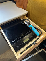 RV rental kitchen drawer featuring a KLVSEG induction cooktop and a BIC lighter for portable cooking.