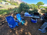Outdoor camp setup with Tommy Bahama chairs, camping gear, and snorkel fins, perfect for an RV rental adventure.