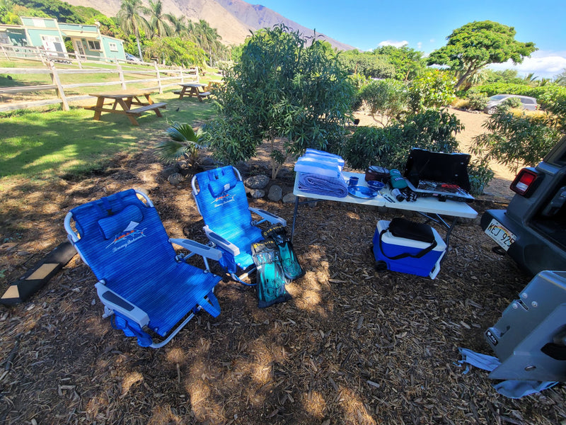 Outdoor camp setup with Tommy Bahama chairs, camping gear, and snorkel fins, perfect for an RV rental adventure. — photo 7