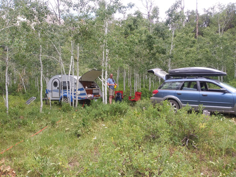 Outdoor camping with a compact RV rental & Subaru.