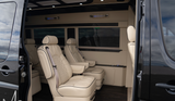 RV rental interior: luxurious & spacious, featuring cream captain's chairs with elegant diamond stitching.