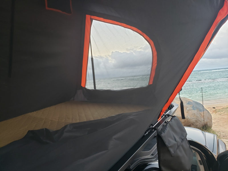 Cozy rooftop tent interior with mattress, seaside view of ocean & beach. Great for your RV rental adventure! — photo 9
