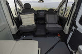 Spacious RV rental interior showing front seats (one with pillow), dashboard, and ocean view. Practical design for comfortable travel.