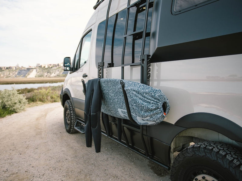  ready for a refreshing rinse.|Modern rv rental interior: A man adjusts overhead storage in a stylish campervan — photo 17