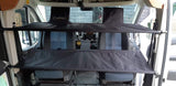 "Cabbunk" system: dual fabric bunks provide extra sleeping/storage in an rv rental's front cabin.