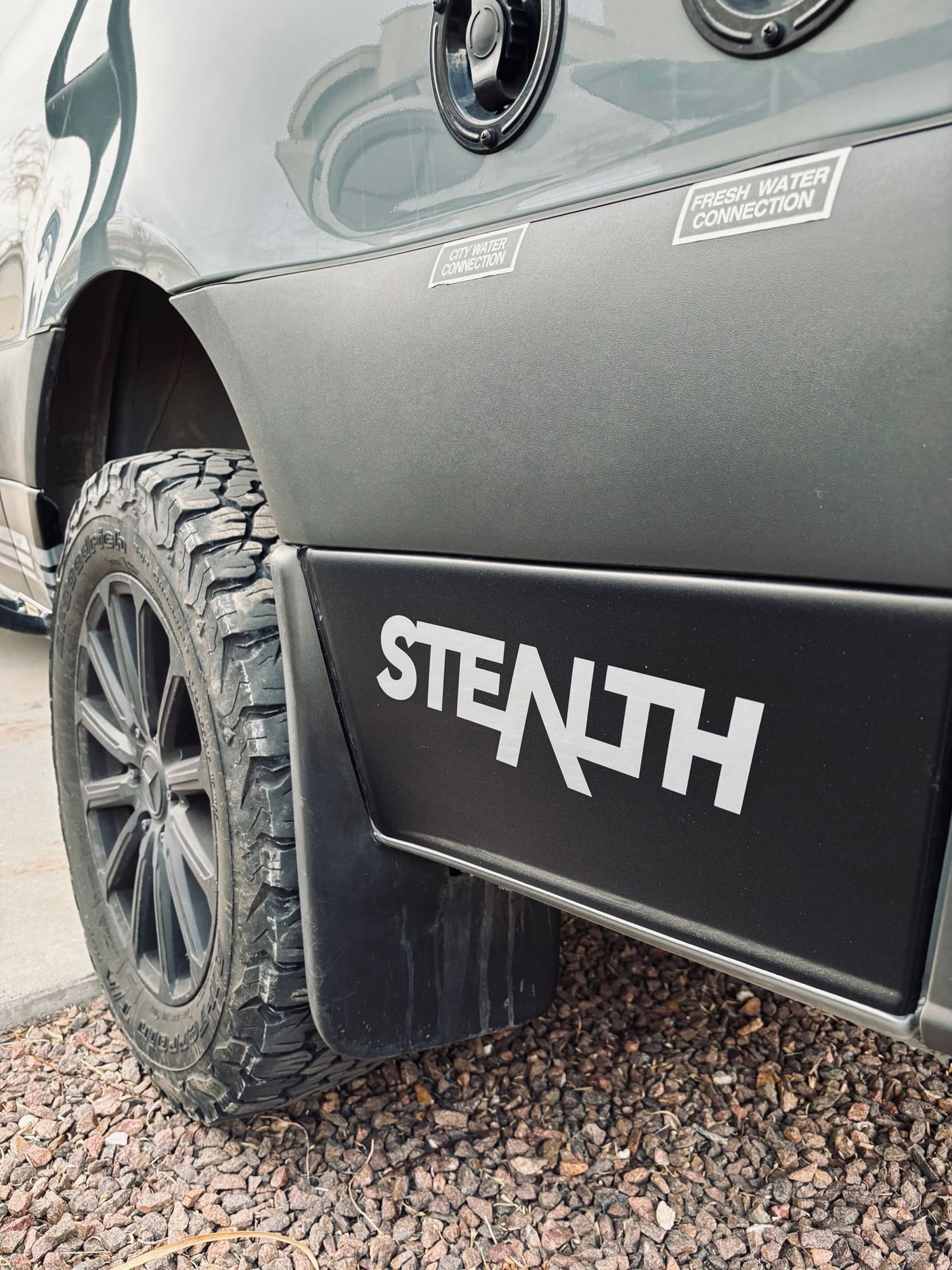 Experience adventure with this rugged RV rental! Features "Stealth" branding, off-road tires, and essential water connections.