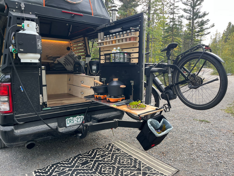RV rental: Rear truck bed camper with full outdoor kitchen, propane stove, spices, and e-bike mount for remote cooking. — photo 13