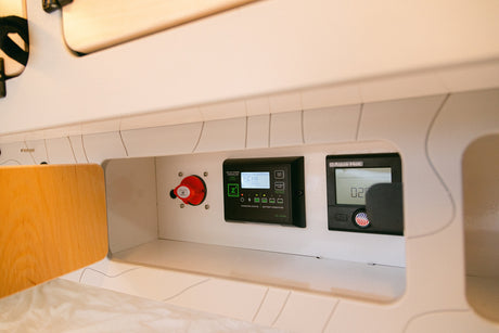 RV rental's power management: Zamp Solar controller, battery switch, and Aqua-Hot display.