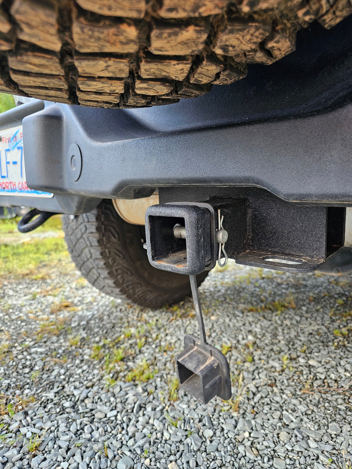 Robust trailer hitch on an RV rental, essential for towing. A spare tire and North Carolina license plate are visible.