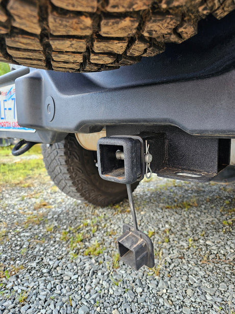 Robust trailer hitch on an RV rental, essential for towing. A spare tire and North Carolina license plate are visible.