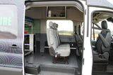 RV rental van interior: gray bench seating, custom storage, and power equipment, ready for mobile adventures.
