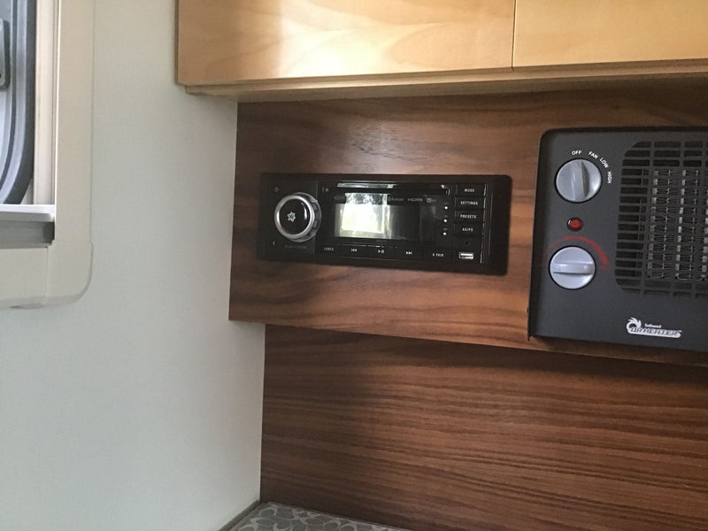 RV rental interior: Built-in stereo with Bluetooth/HDMI and a portable DR HEATER for comfort. Warm wood paneling & cabinets. — photo 14