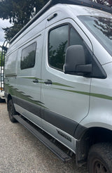 Silver Winnebago Revel adventure rv rental with distinct green decals, running boards, and a roof rack.