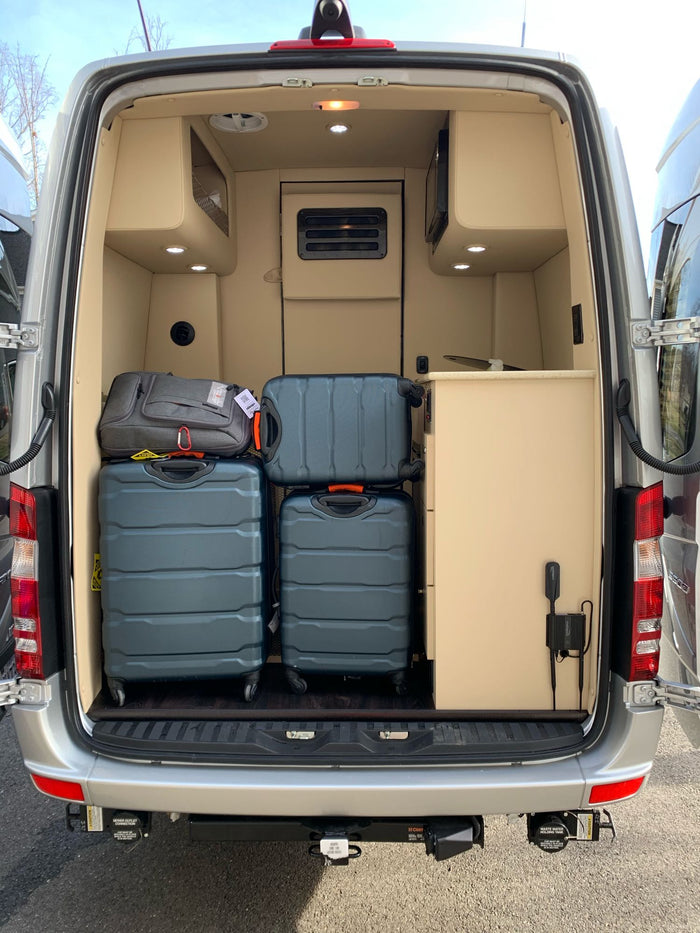  and plush seating.|Explore our luxurious RV rental interior. Features include plush cream quilted leather seats