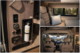 This RV rental interior features safety controls, a fire extinguisher, cozy rear seating, and scenic mountain views from the cockpit.