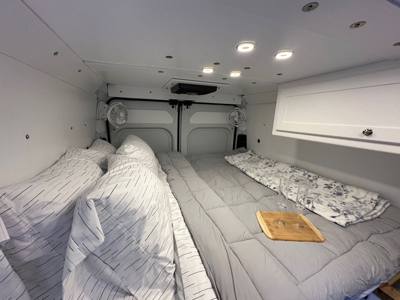  and compact kitchen area.|Experience comfort in this RV rental's sleeping area — photo 11
