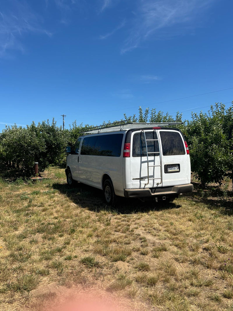  kids nearby.|White conversion van with roof rack & rear bike rack — photo 2