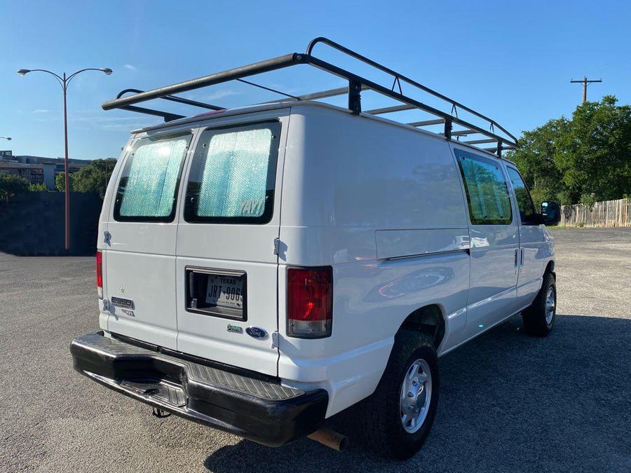 reading a book by the river at sunset. Cozy van life scene.|Step inside this RV rental's camper van interior. Features include wooden paneling