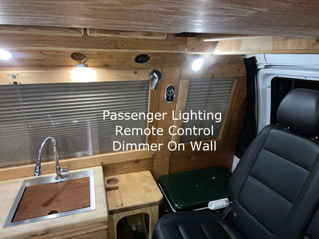 Discover this RV rental's cozy wooden interior featuring a sink, passenger seat, and dimmable lighting.