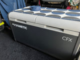 Dometic CFX portable cooler with a fun patterned mat and EnKore coasters inside an RV rental. Ready for adventure!