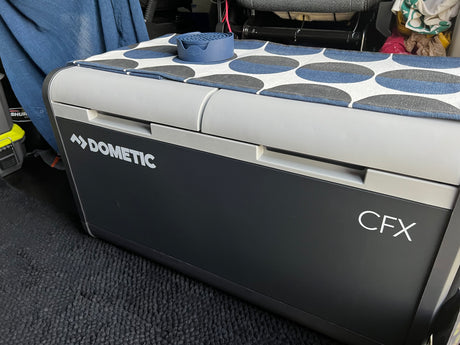 Dometic CFX portable cooler with a fun patterned mat and EnKore coasters inside an RV rental. Ready for adventure!